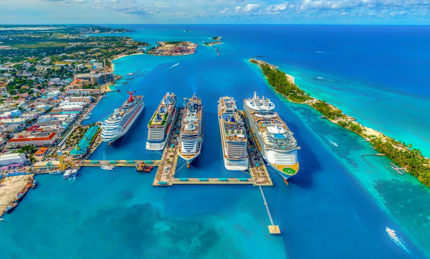 Cruise ships docked in a bright tropical harbor
